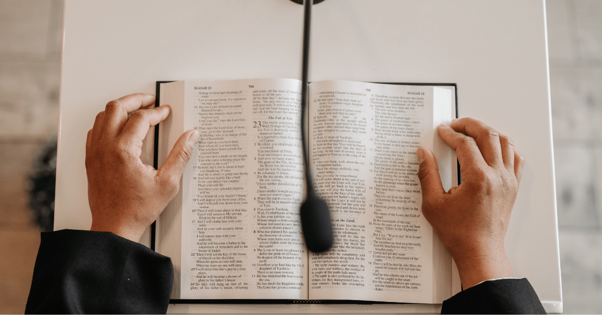 A pastor preaching a sermon from the wooden pulpit of a small country church