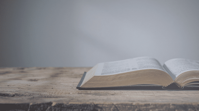 Open Bible on Rustic Wooden Table Church Equip. The Truth About the Bible's Most Popular Verses